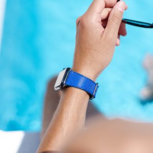 Deep-Ocean-Apple-watch-blue-rubber-band-with-a-swimming-pool-behind