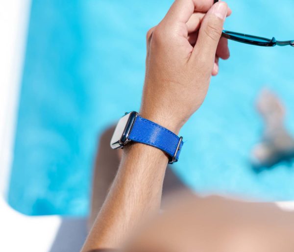 Deep-Ocean-Apple-watch-blue-rubber-band-with-a-swimming-pool-behind