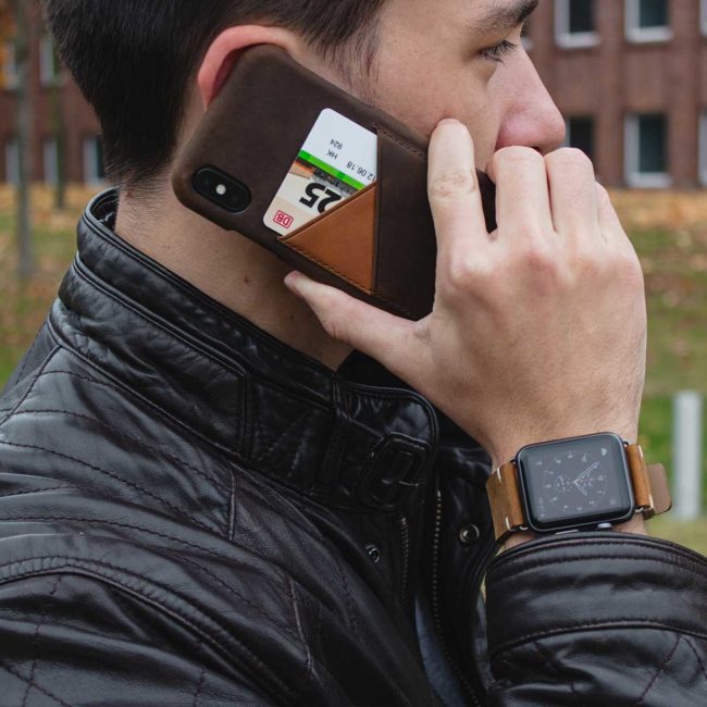 Cigar-dark-brown-iPhone-leather-case-close-to-a-hear-for-him-with-a-black-leather-jacket-outfit