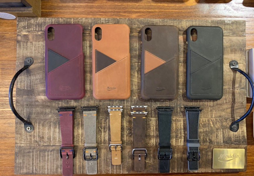 Bands-and-iphone-leather-cases-on-top-of-a-vintage-wood-table
