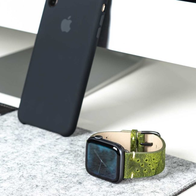 Hope-Applw-watch-green-calf-leather-band-with-30-holes-close-to-a-black-iphone