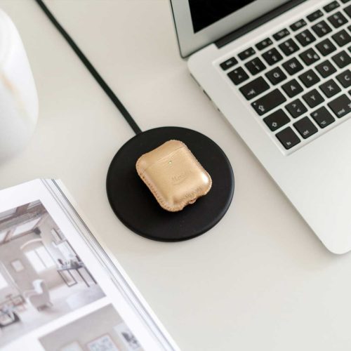 Topaz-Airpods-gold-leather-case-on-a-wireless-charger