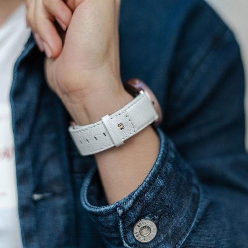 Galaxy-watch-active-white-leather-band-with-focus-on-monogram-with-a-sportwear-outfit-for-her