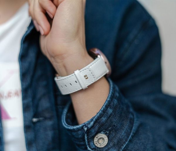 Galaxy-watch-active-white-leather-band-with-focus-on-monogram-with-a-sportwear-outfit-for-her