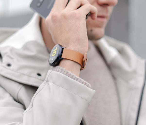galaxy-watch-active-tawny-on-wrist-for-him-close-to-a-grey-coat