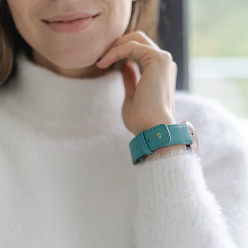 galaxy-watch-active-turquoise-on-wrist-for-her-with-a-white-shirt