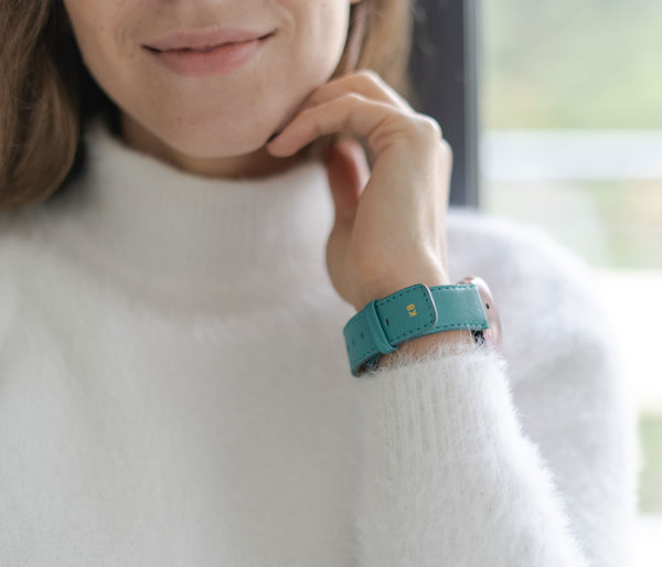 galaxy-watch-active-turquoise-on-wrist-for-her-with-a-white-shirt