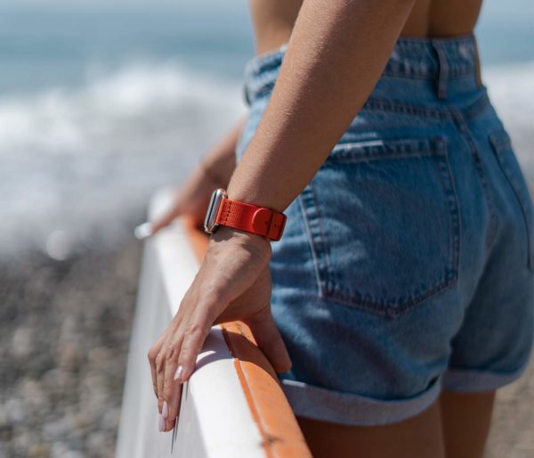 Apple-watch-orange-tide-band-recycled-ocean-plastic-woman-with-a-paddle-surf-going-to-sea