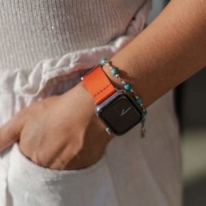 Apple-watch-orange-tide-band-recycled-ocean-plastic-woman-with-hand-in-the-pocket