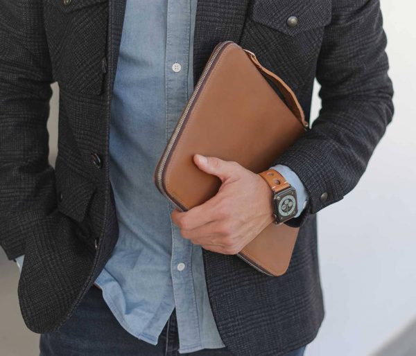 AW light brown full grain leather band for man handling a macbook sleeve