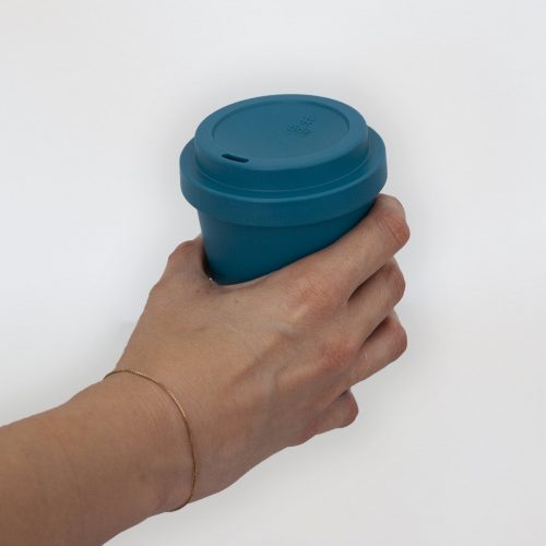 Recycled Ocean bound plastic tide cup on woman hand