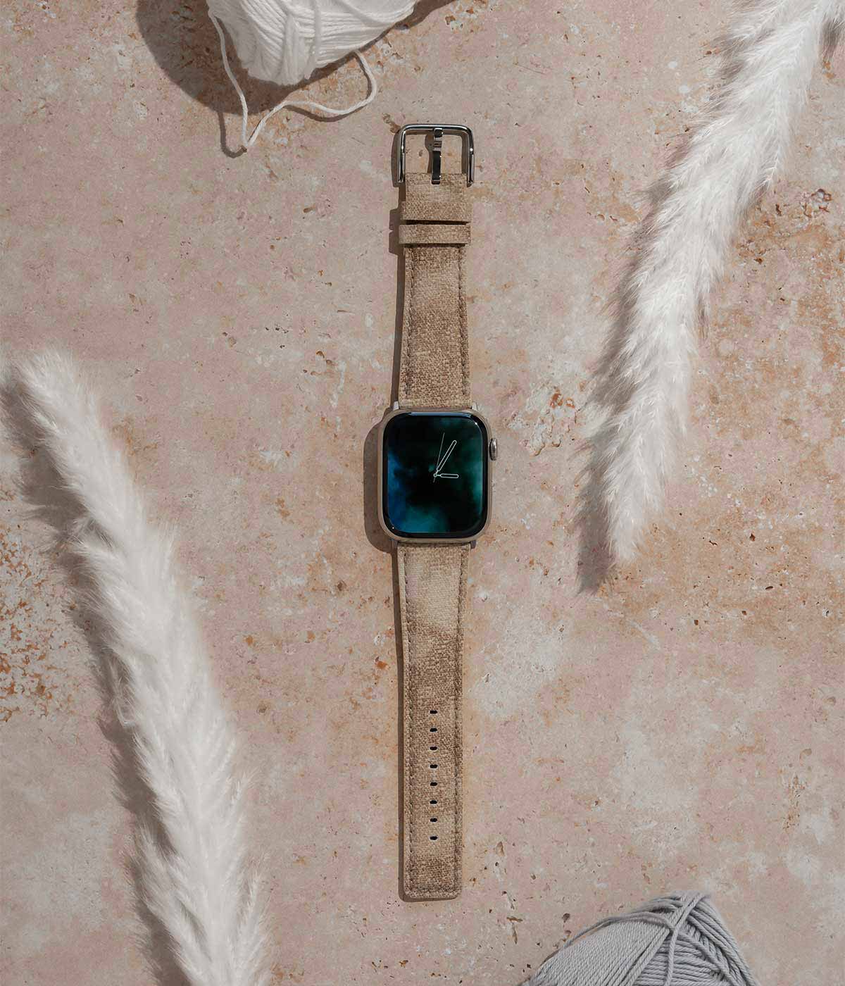 Recycled_Grey_Apple_watch_band_flat_lay_in_the_middle_of_cotton_props